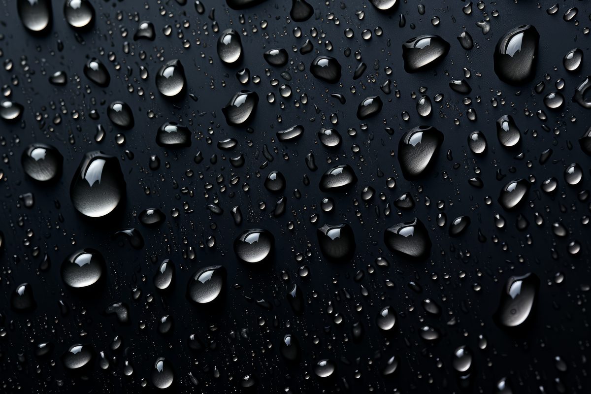 Background of water droplets splashed on a black surface