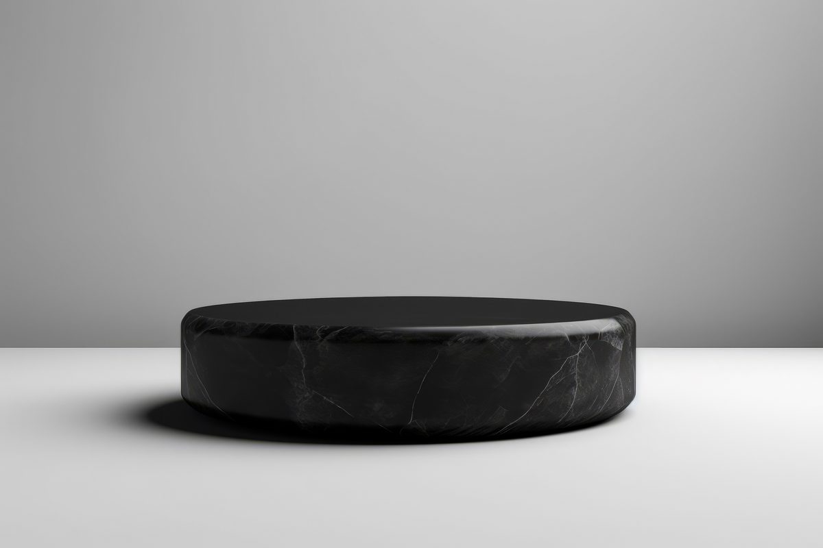 Elegant round black marble podium for product presentation on a white background