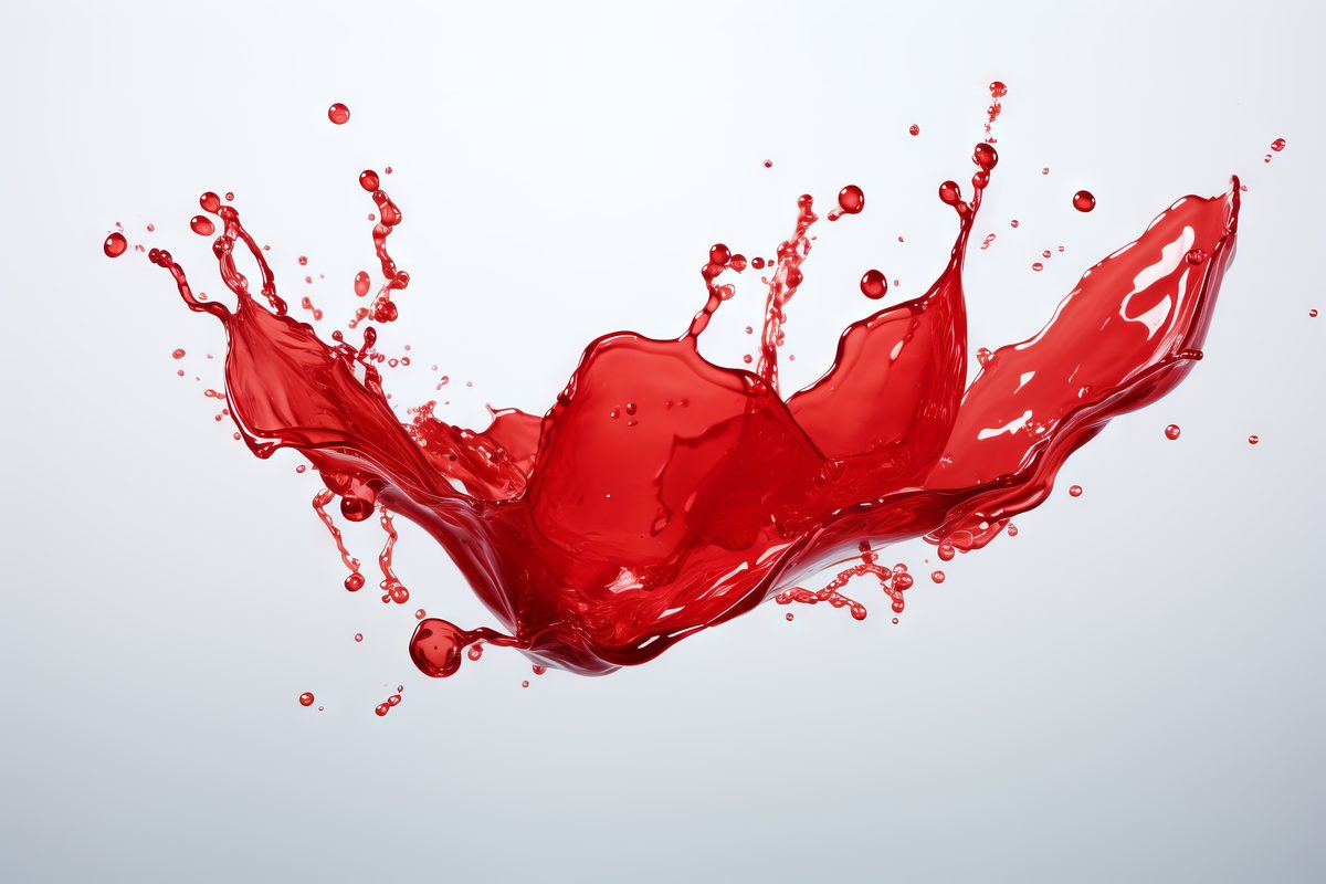 Image of red translucent liquid stain on white background