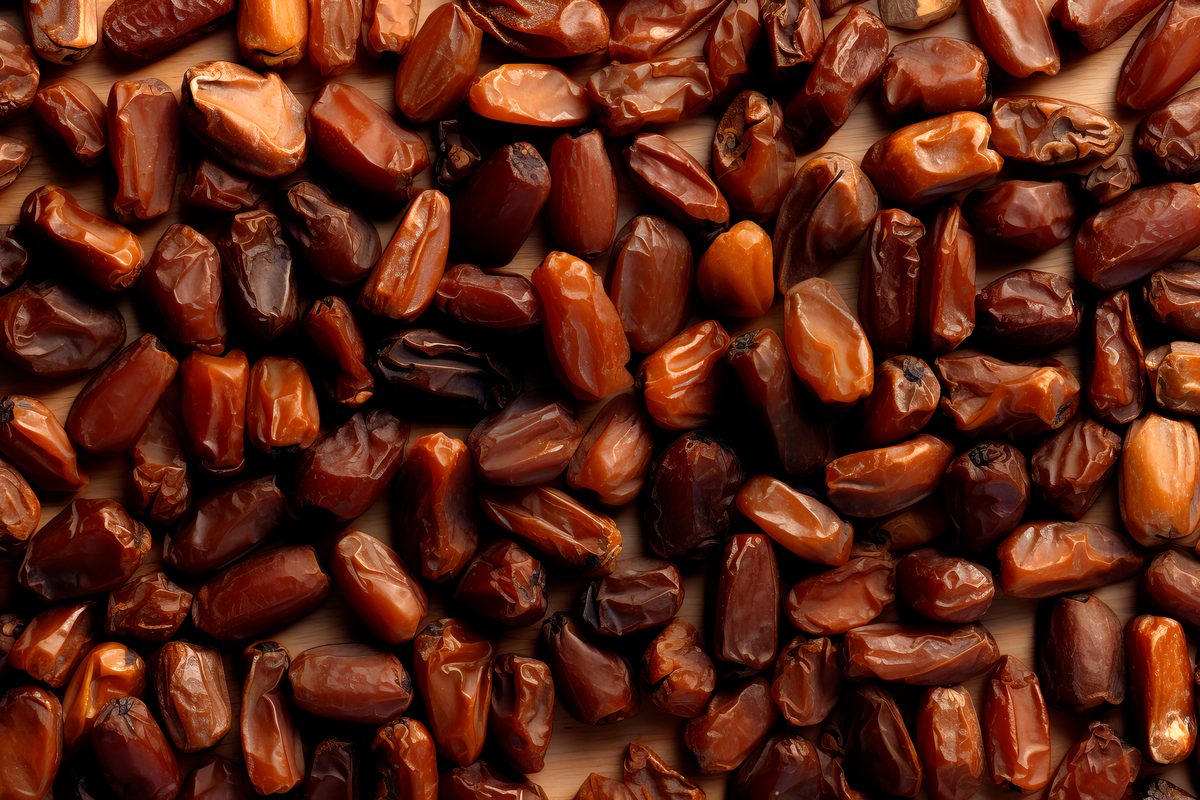 Photo of wooden table covered with dried dates