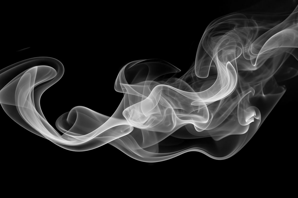 Waving smoke floating over black backdrop