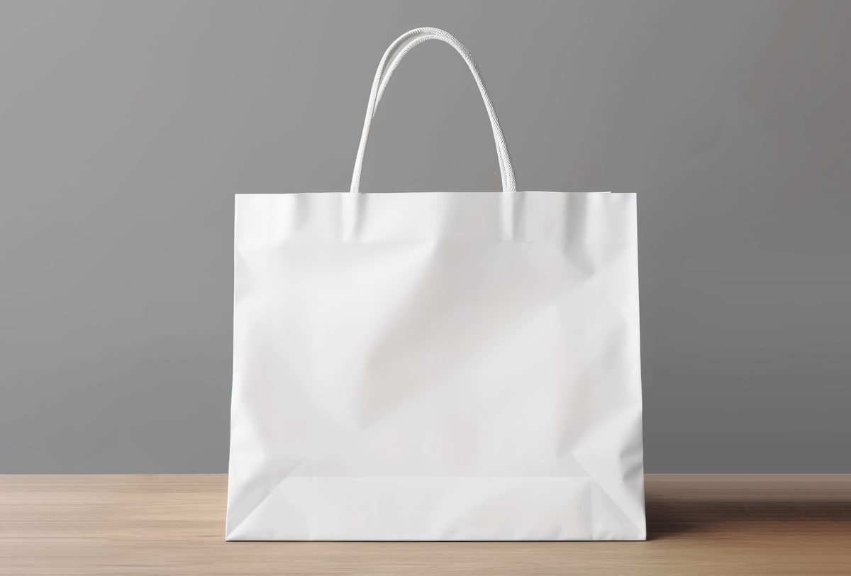 White paper shopping bag on wooden surface