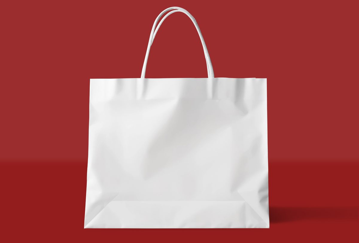 White paper shopping bag set on red background