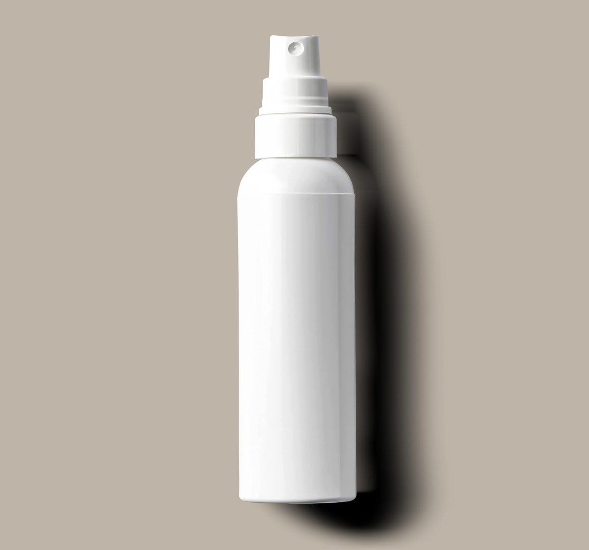 White plastic spray bottle on a neutral background