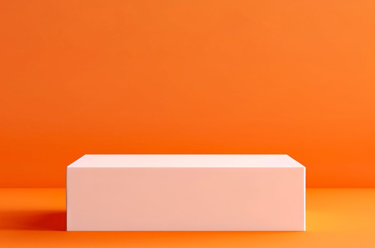 White squared empty podium for product presentation over a bright orange background