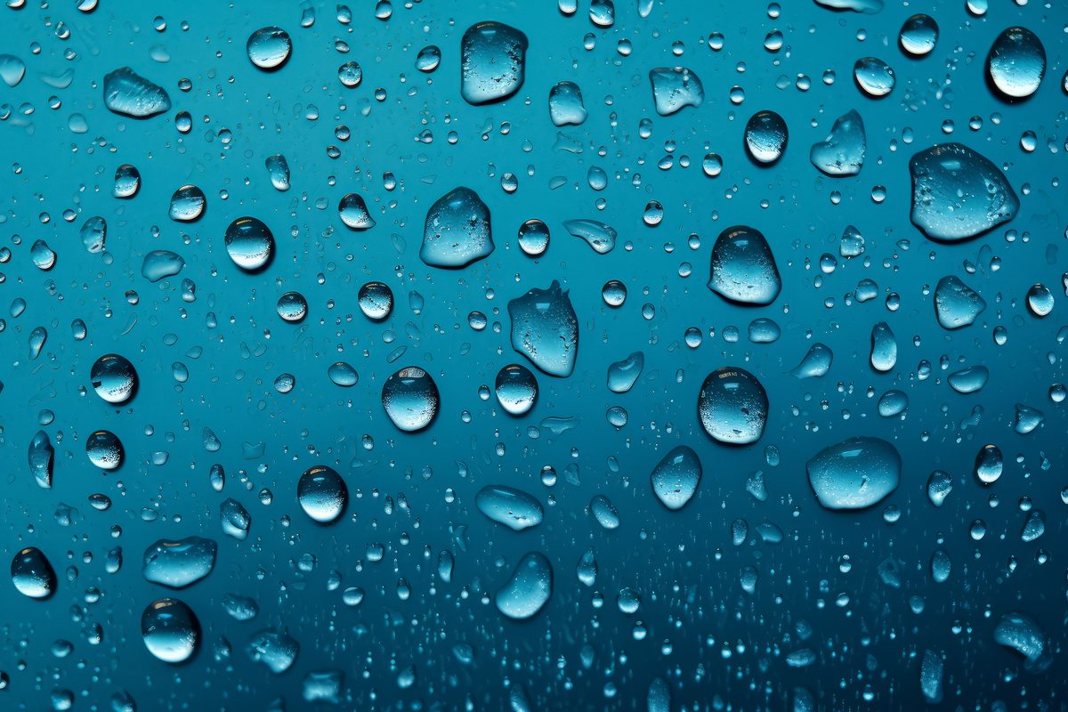 Background of water droplets splashed on a blue surface