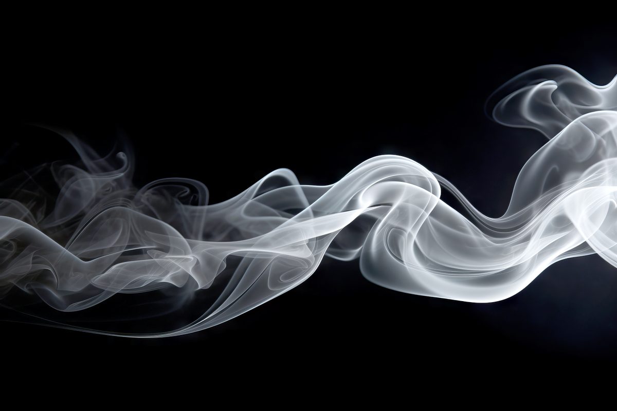 Waving smoke floating over black background