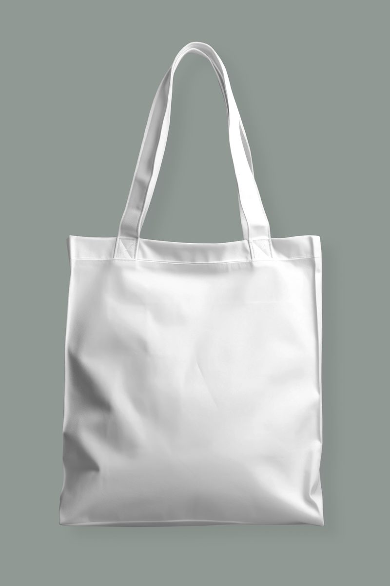 White cotton tote bag isolated on pale green background
