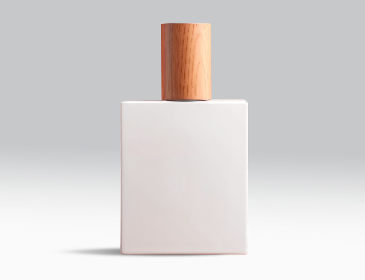 White glass bottle with wooden cap on light background