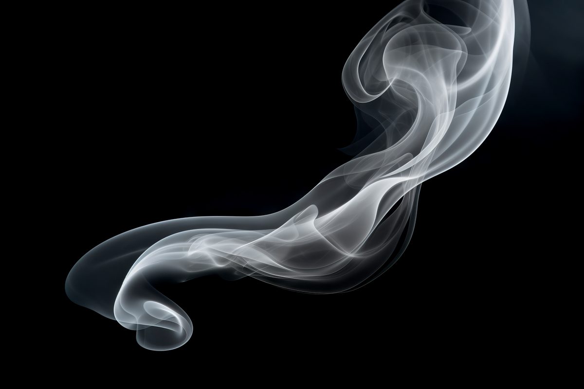 White waving smoke floating over a black backdrop