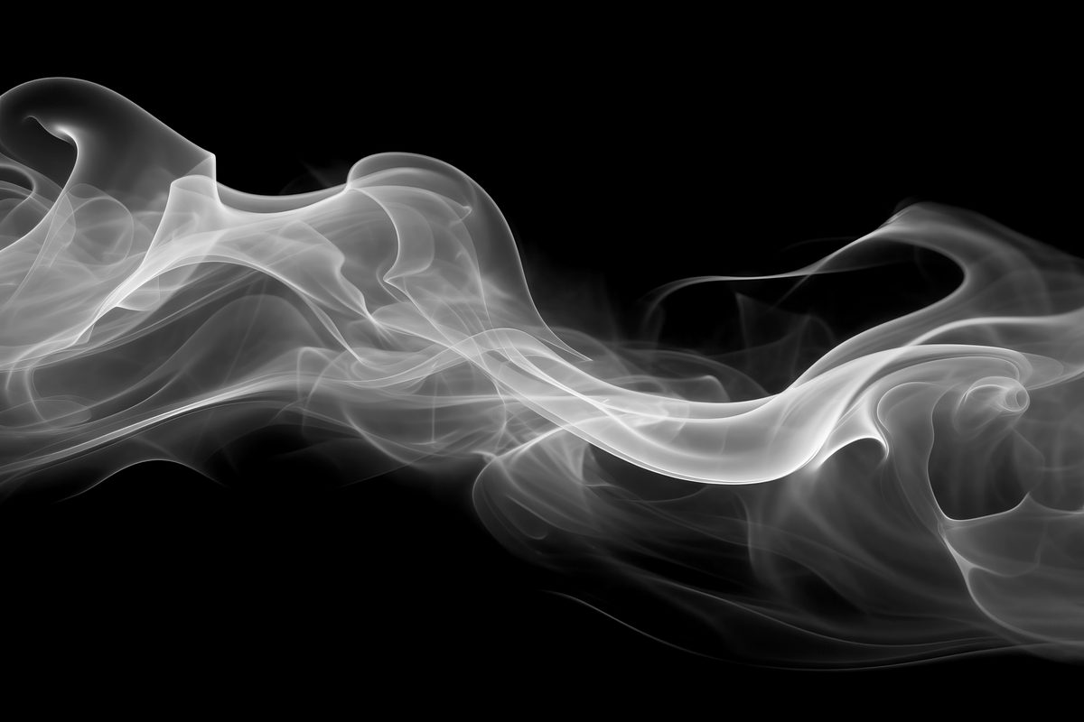 White waving smoke floating over a black background