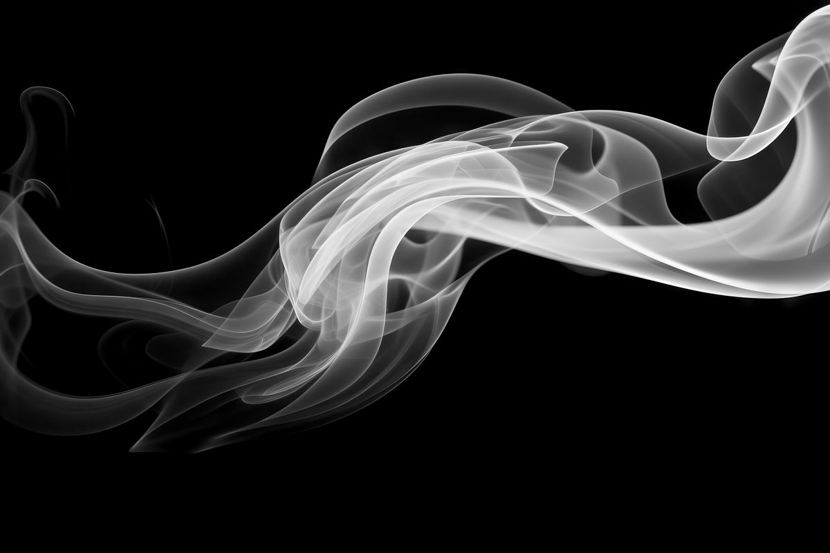White waving smoke floating over black backdrop