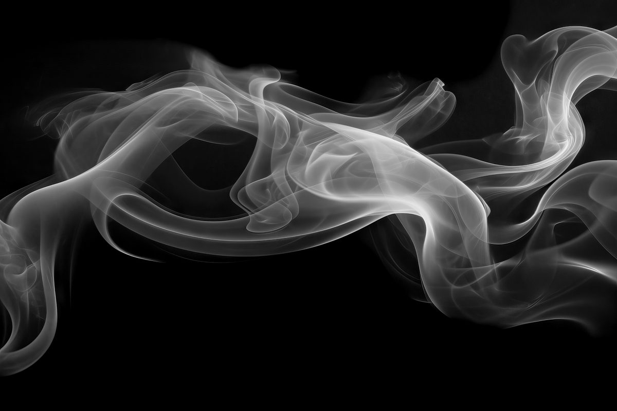 White waving smoke floating over black background