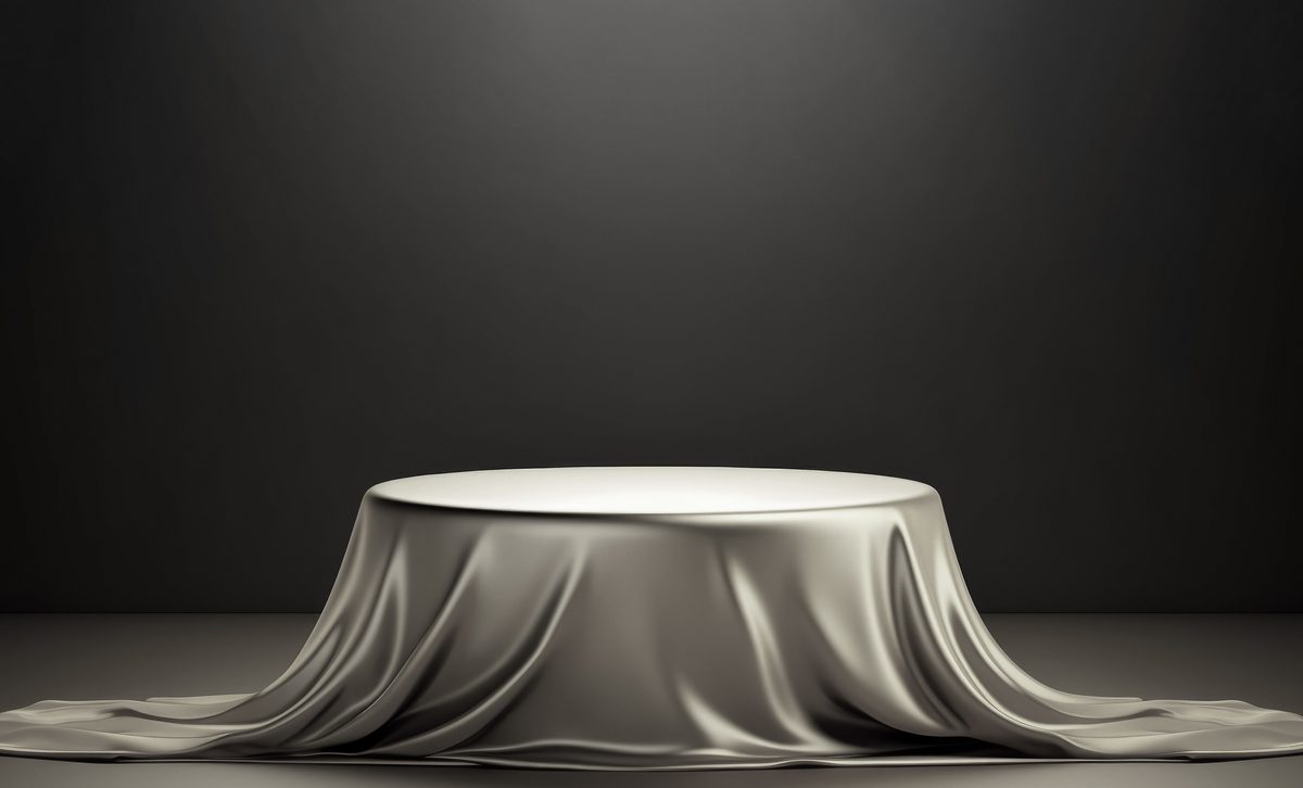 Empty podium covered with a metallic cloth for product presentation on a dark background